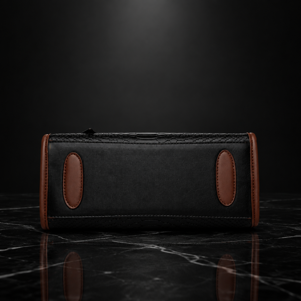 Underside view of black tote with brown base patches on dark marble