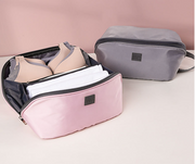 Interior view of the Travel Portable Multi-Function Organizer showing mesh pockets and elastic loops for accessories.
