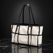 Front view of a Black Grid Canvas Tote Bag with a minimalist square pattern and sturdy shoulder straps.