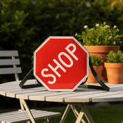 Red sign bag on the garden table, upright hero